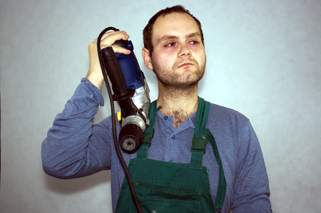 Man of worker and hammer drill の写真素材