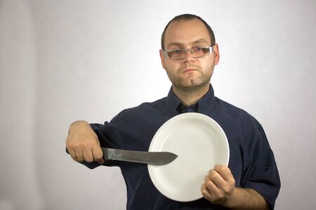 Man with kitchen accessories on whiteの写真素材