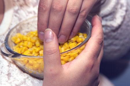 eating corn from the bowlの写真素材