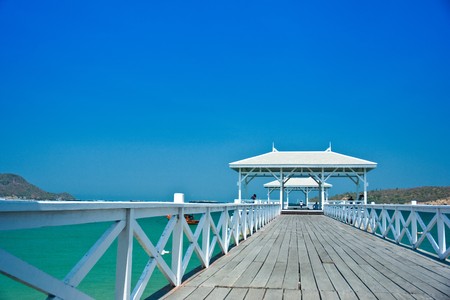 White wood bridge is along in the seaの写真素材