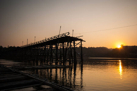 Sunset at the longest wooden bridge and floating Town in Sangklaburi Kanchanaburi Thailand