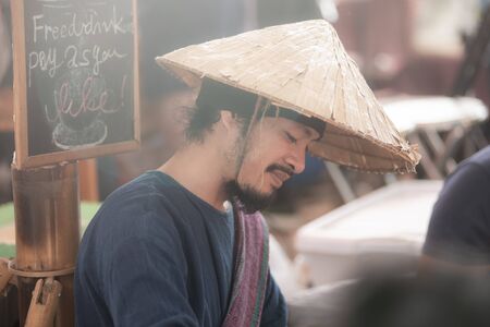 Chiangmai, Jing Jai Market, Muang Chiangmai, Thailand- December 02, 2018: A  blur smiling man in Thai suite  making a drip coffee at Jing Jai Market, the organic market, Muang District, Chiangmai, Thailandのeditorial素材