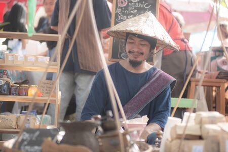 Chiangmai, Jing Jai Market, Muang Chiangmai, Thailand- December 02, 2018: A  blur smiling man in Thai suite  making a drip coffee at Jing Jai Market, the organic market, Muang District, Chiangmai, Thailandのeditorial素材