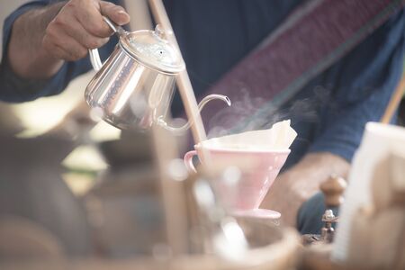 Chiangmai, Jing Jai Market, Muang Chiangmai, Thailand- December 02, 2018: A  blur smiling man in Thai suite  making a drip coffee at Jing Jai Market, the organic market, Muang District, Chiangmai, Thailandのeditorial素材