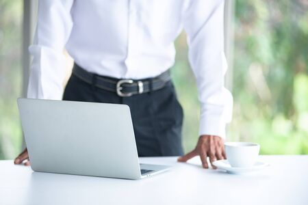 Blur Asian Business old man with white shirt  is and drinking coffee, working with labtop, thinking, planning, and meeting at the office about the success of the companyの写真素材