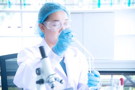 Asian woman scientist, researcher, technician, or student conducted research or experiment by using...