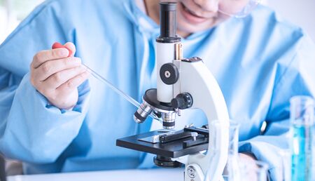 Asian woman scientist, researcher, technician, or student conducted research or experiment by using...