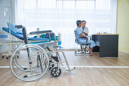 Blur aging society, health care and medical concept. The doctor diagnose the patient' health in the hospital. Closed up wheelchair the medical equipment for assistance patients, elders or disabled personの写真素材