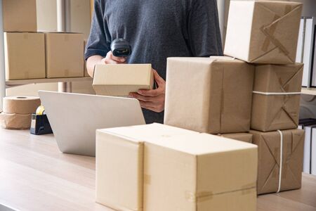 Asian young smart businessman or entrepreneur  owner of SME online, delivery business checking...