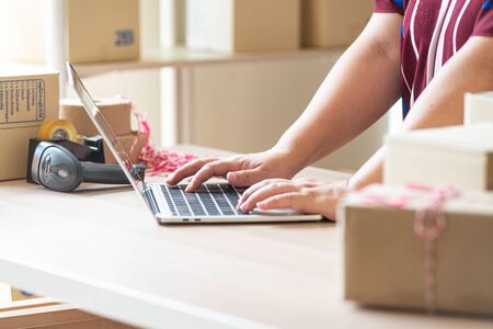 Asian young smart businessman or entrepreneur  owner of SME online, delivery business checking...