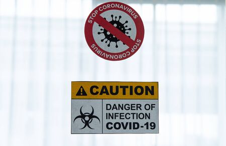 COVID-19, Corona Virus outbreak quarantine and epidemic spread healthcare concept. Caution and danger of infection COVID-19 coronavirus outbreak control sign at quarantine room in hospitalの写真素材