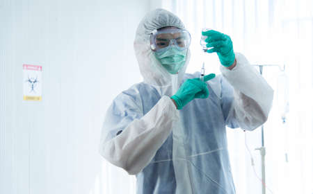 Doctors in protective suit is monitoring and injection the patient infected with CORONA VISRUS or...