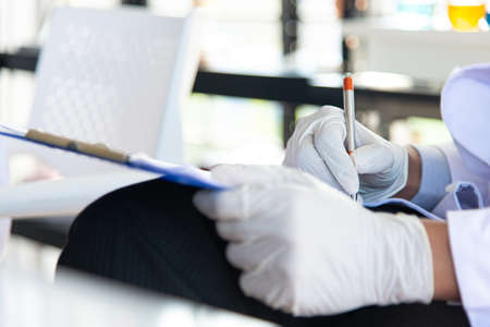 Doctor checking patient symptom and take note on the pad.Researcher discover COVID-19 or CORONA...