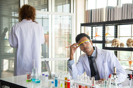 Young scientists or researchers wear eye glasses doing research in laboratory. Scientist working on...