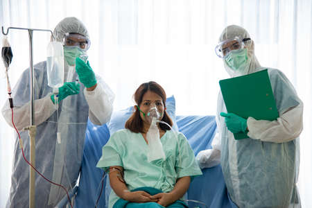Asian woman patient feeling happy recovering from  virus infection. Medical staffs and patient is in...