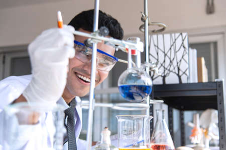 Young scientists or researchers doing chemical research in laboratory. Scientist discovering new drug or vaccine.の写真素材
