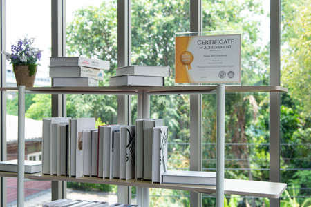 Certificate of achievement on the bookshelf in the modern library