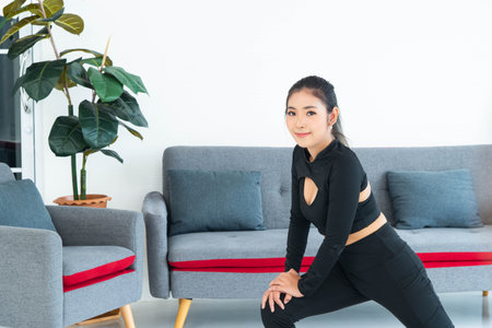 Asian young healthy woman in sportware practicing yoga at home, Sport girl exercise  in living room...