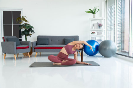 Asian young healthy woman in sportware practicing yoga at home, Sport girl meditating  in living...