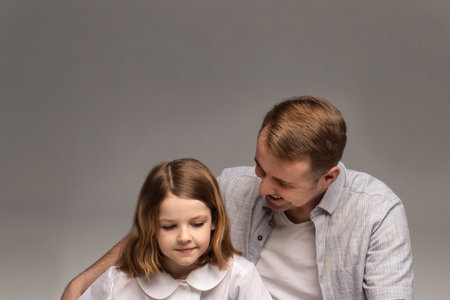 portrait of happy father and cheerful son, cute boy playing with dad in the house, child hugging father, dad playing with children, dad hugs daughterの写真素材