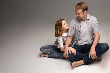 portrait of happy father and cheerful son, cute boy playing with dad in the house, child hugging father, dad playing with children, dad hugs daughterの写真素材