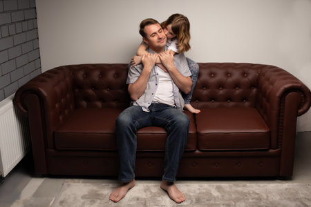 portrait of happy father and cheerful ,child cute boy playing with dad in the house, child hugging father, dad playing with children, dad hugs daughterの写真素材