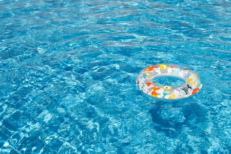 a beautiful pool with blue water and a bright, pink circle for swimming.の写真素材