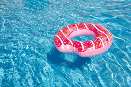 a beautiful pool with blue water and a bright, pink circle for swimming. blue background, sea background.の写真素材