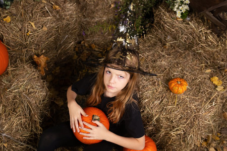 portreit happy girl on Halloween. Funny children in carnival costumes indoors. Cheerful children...
