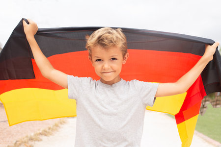 happy, cheerful boy holding germany flagの写真素材