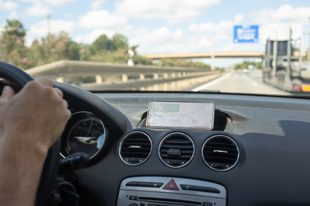 A traveler navigates through Spain's picturesque landscapes, enjoying the open road with a GPS...