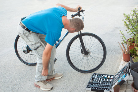 Bicycle repair and maintenance concept. Young man repairing his bicycle.の写真素材
