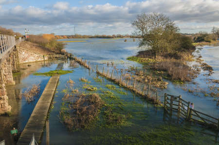 Flooded footpath, walkway on the river Nene Cambridgshire near Wandsford England