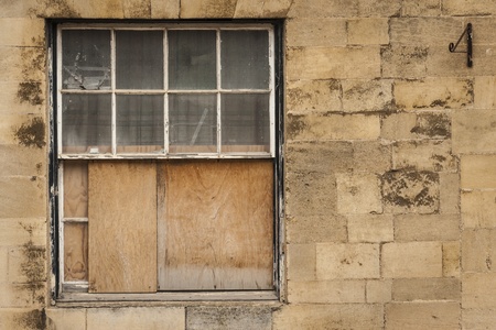 Old wooden sash window half boarded upの写真素材