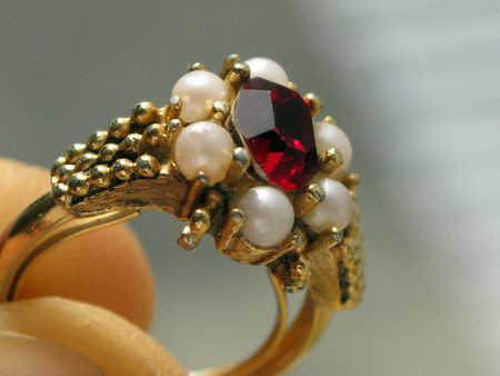 Faux ruby and pearl golden ringの写真素材