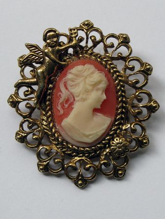 Cameo on clay colored background with cherub golden frameの写真素材