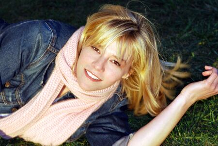 Blonde Girl Outside with Jean Jacket and Pink Scarfの写真素材