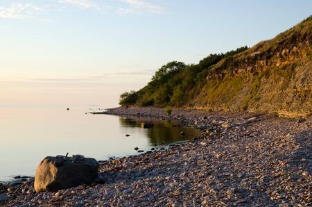 Calm summer evening at a bay with deep steepの写真素材
