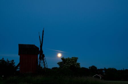 Moon over windmill and blossom elder treeの写真素材
