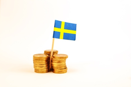 Coin piles and a swedish flagの写真素材