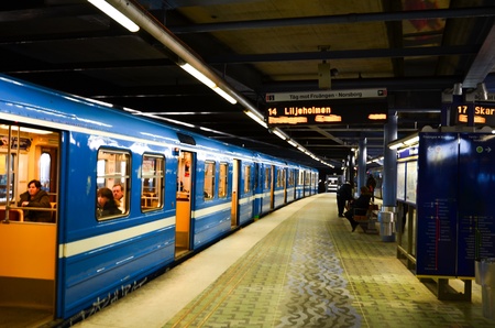 Train with open doors waiting at a station by Stockholm metro