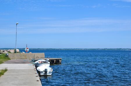 Small boats at a pier by the swedish island Oland の写真素材