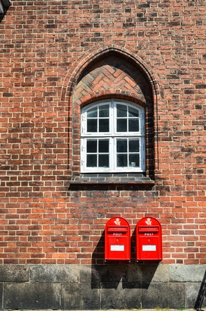 Two red postboxes at the wall of old city hall in Roskilde, Denmark.のeditorial素材