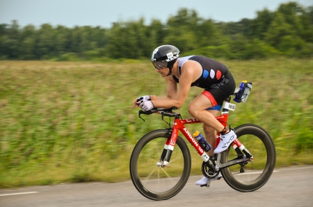 The french thriathlete Yan Busset in action at the bike course in Ironman Kalmar, Sweden 2013 on August 17th 2013のeditorial素材