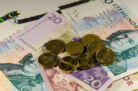 Swedish 10 SEK coins at partly unfocused banknotesの写真素材