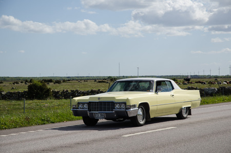 OLAND SWEDEN  MAY 23 2015: Classic car Cadillac de Ville 1969 on the road heading for an old timer car meeting at the swedish island Oland.のeditorial素材
