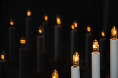Group of electric candles reflecting in a window