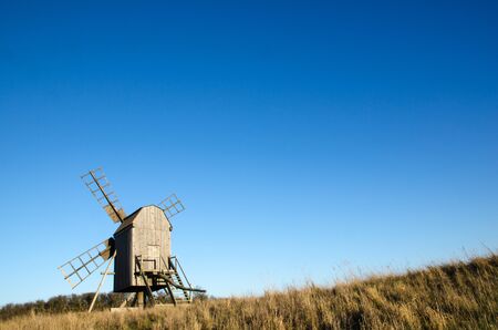 Sunlit old traditional wooden windmill on at the swedish island Oland, the island of sun and wind