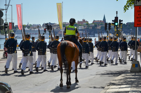 Stockholm, Sweden - June 13, 2016: Police escort when the royal guards marches for changing the guards at the royal castle in Stockholm, Swedenのeditorial素材