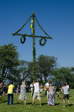 Borgholm, Oland, Sweden - June 24, 2016: Swedes celebrating midsummer by dancing around a midsummer poleのeditorial素材